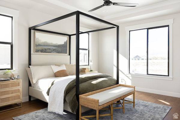 Bedroom featuring multiple windows, ceiling fan, and dark hardwood / wood-style floors