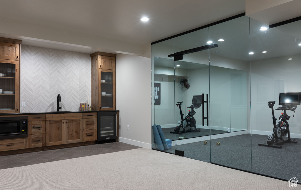 Workout area featuring wine cooler and sink