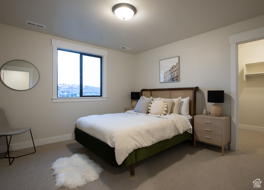 Bedroom featuring light colored carpet