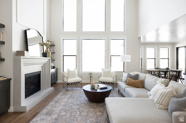 Living room featuring a towering ceiling and hardwood / wood-style floors