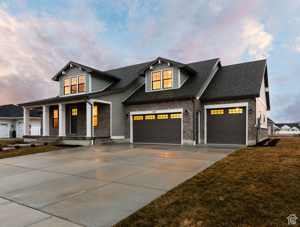 View of front of property with a front lawn and a garage