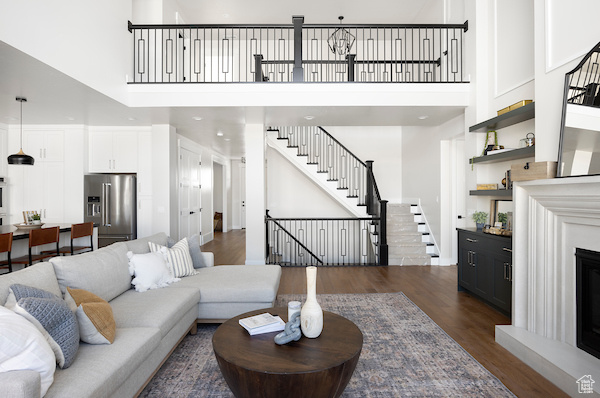 Living room featuring a high ceiling and dark hardwood / wood-style floors