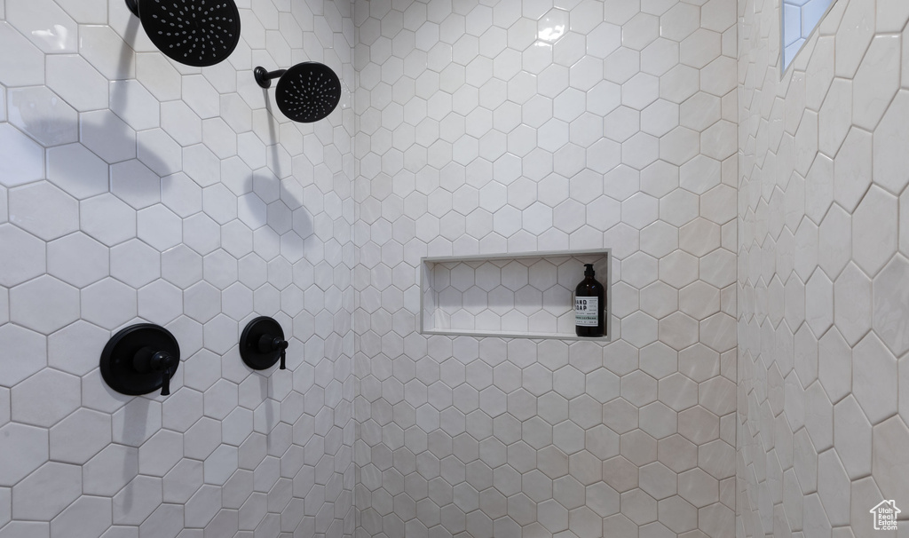 Room details featuring a tile shower