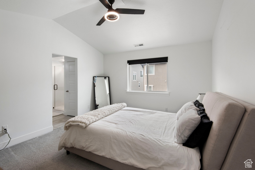 Bedroom featuring lofted ceiling, light colored carpet, and ceiling fan