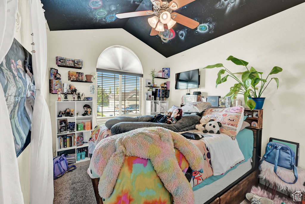 Carpeted bedroom with lofted ceiling and ceiling fan