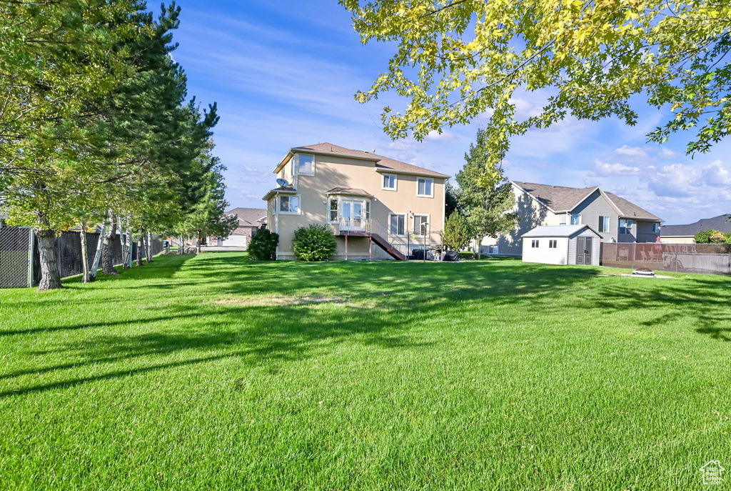 Rear view of house with a yard