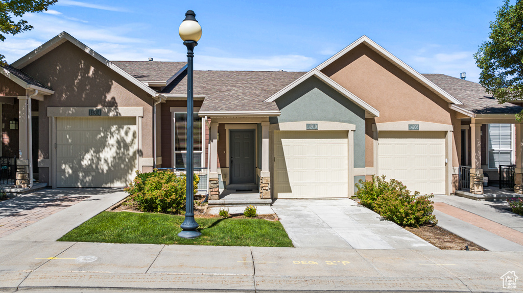 View of front facade featuring a garage