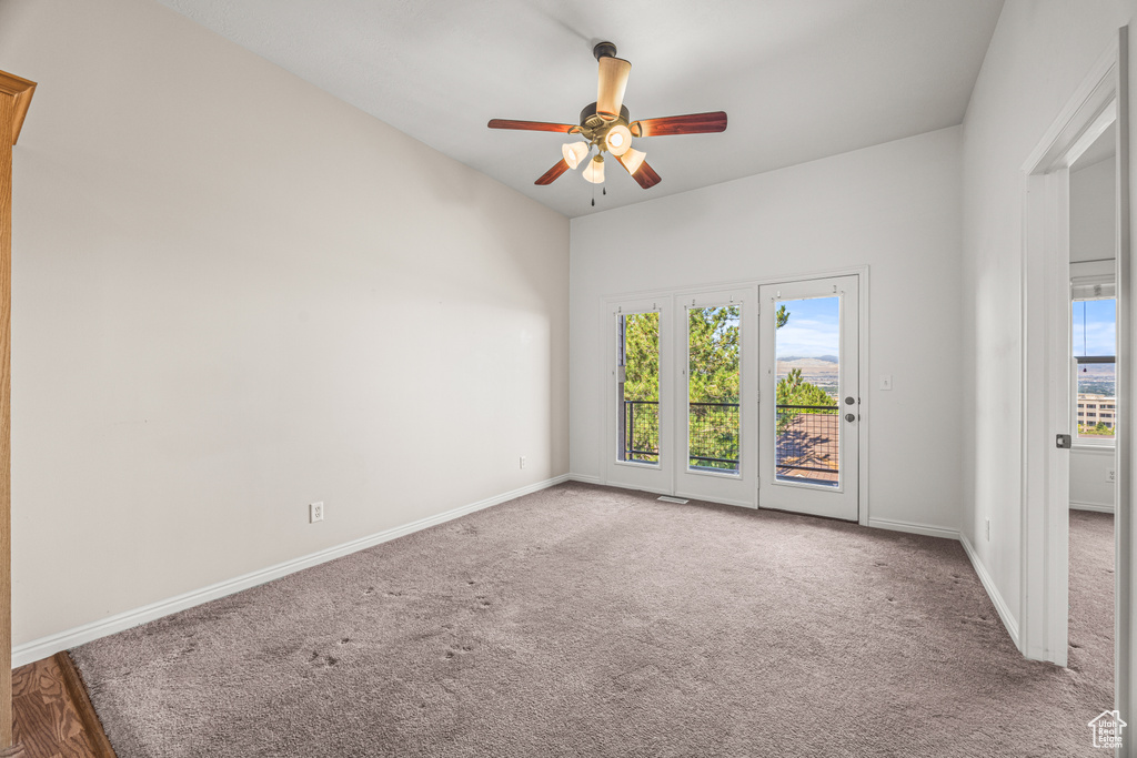 Spare room with ceiling fan and carpet flooring