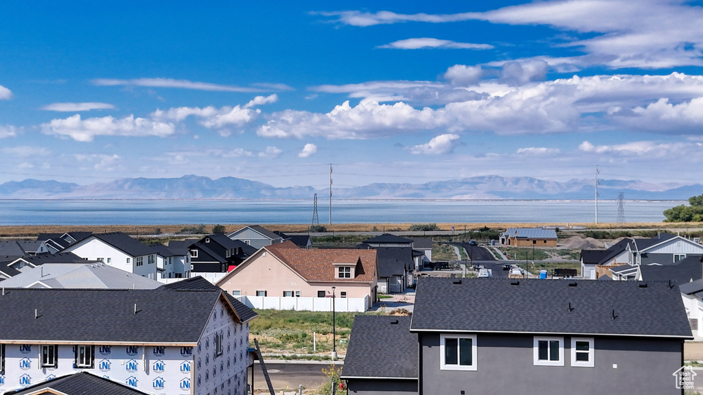 Birds eye view of property featuring a water and mountain view