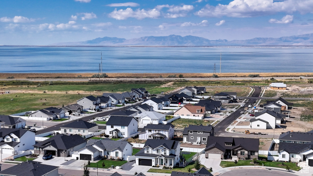 Drone / aerial view featuring a water and mountain view