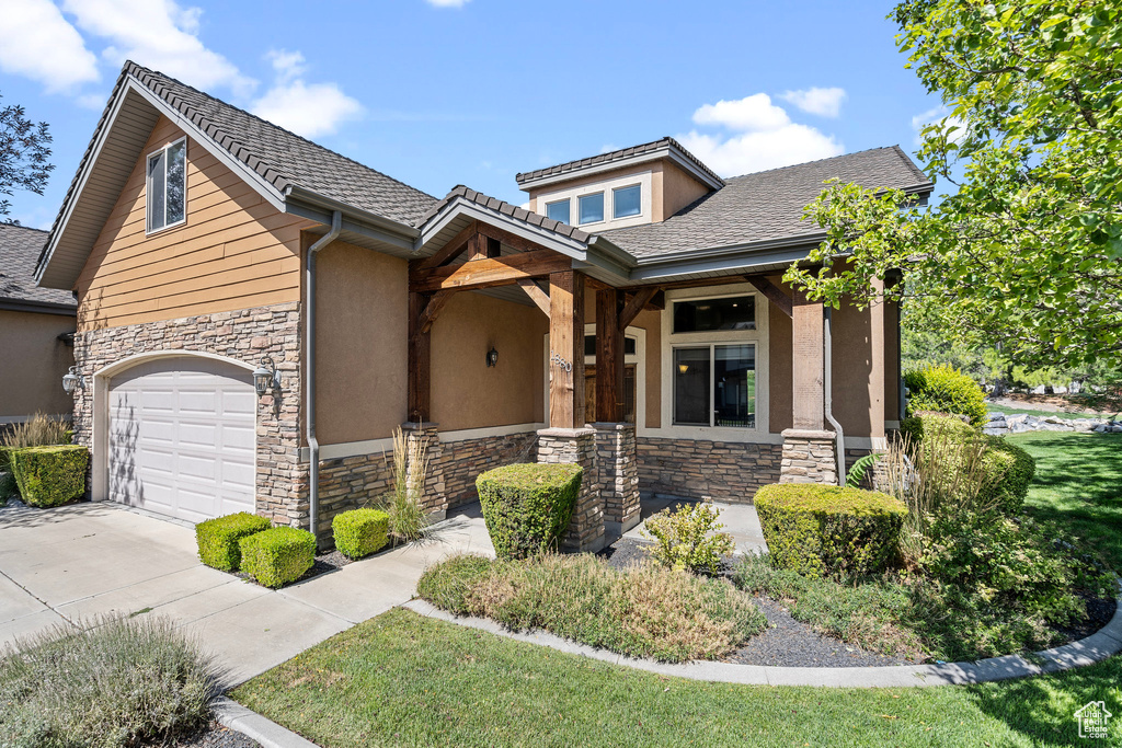 View of front of house with a garage and covered porch