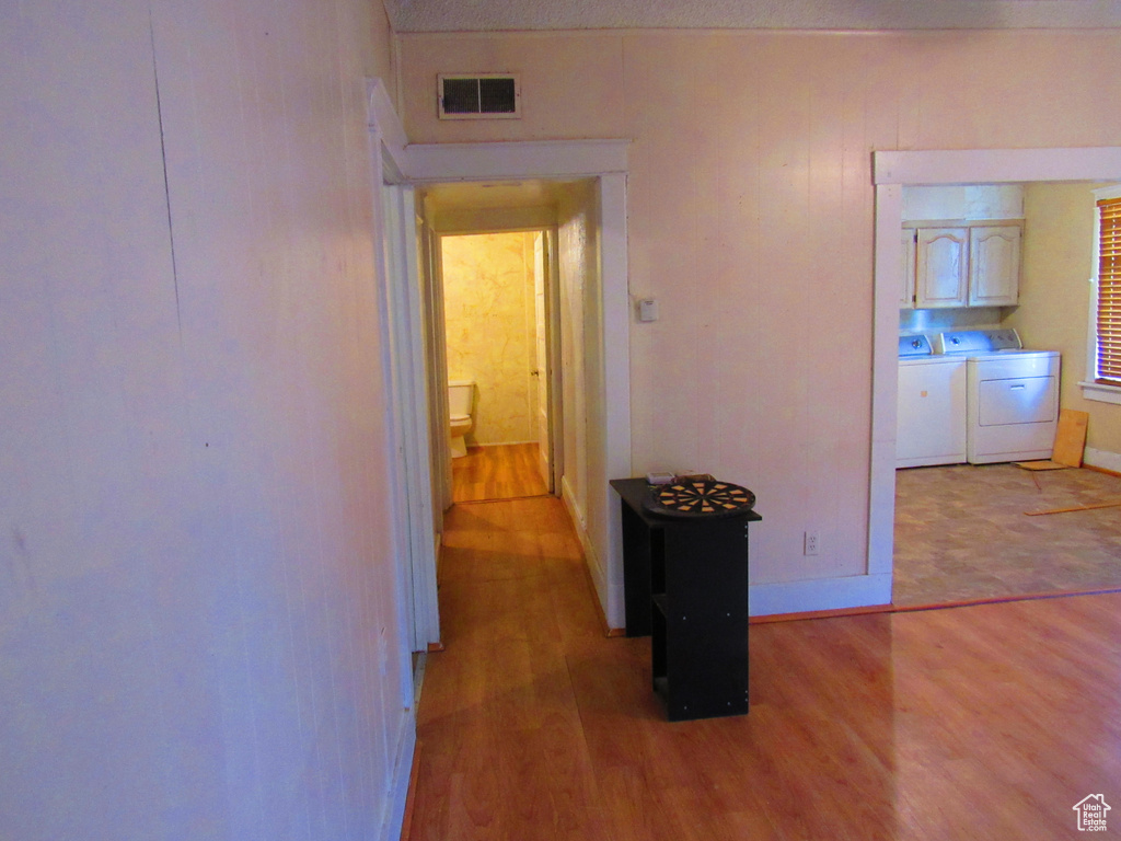 Hallway featuring light hardwood / wood-style floors and washer and clothes dryer