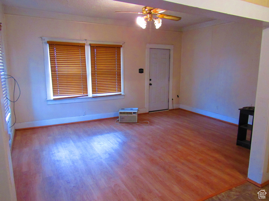 Empty room featuring light wood-type flooring and ceiling fan