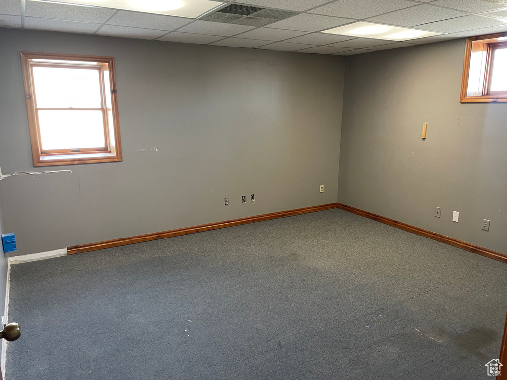 Carpeted spare room with a paneled ceiling