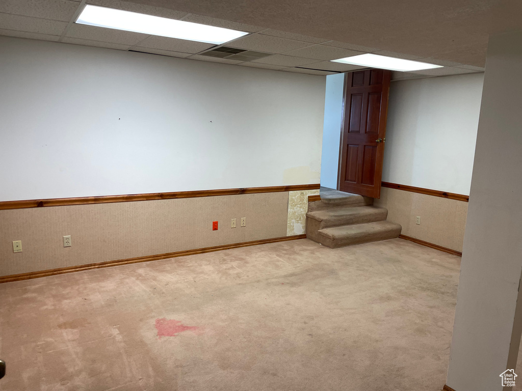 Carpeted spare room with a paneled ceiling