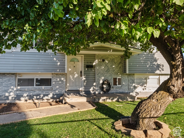 Rear view of property featuring a yard