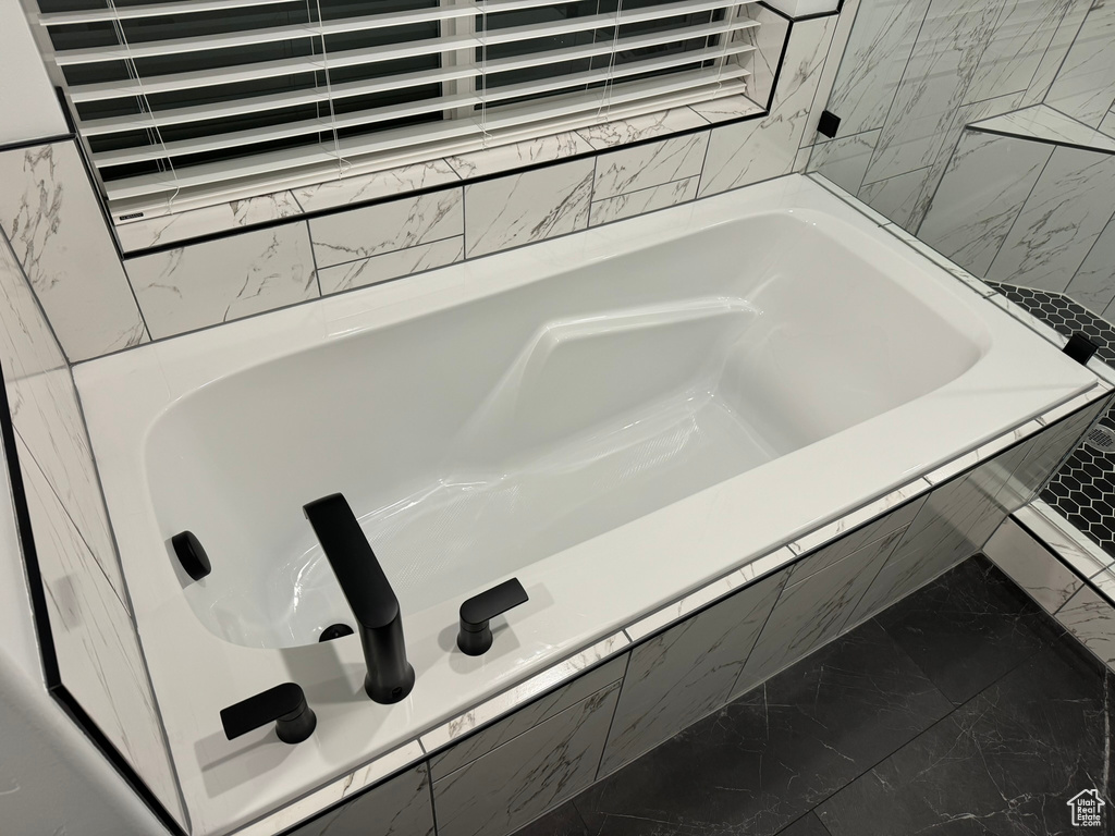 Bathroom featuring tiled tub