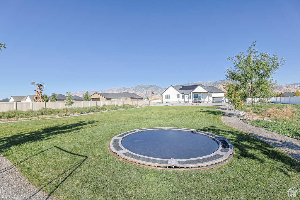 View of yard featuring a mountain view and a trampoline