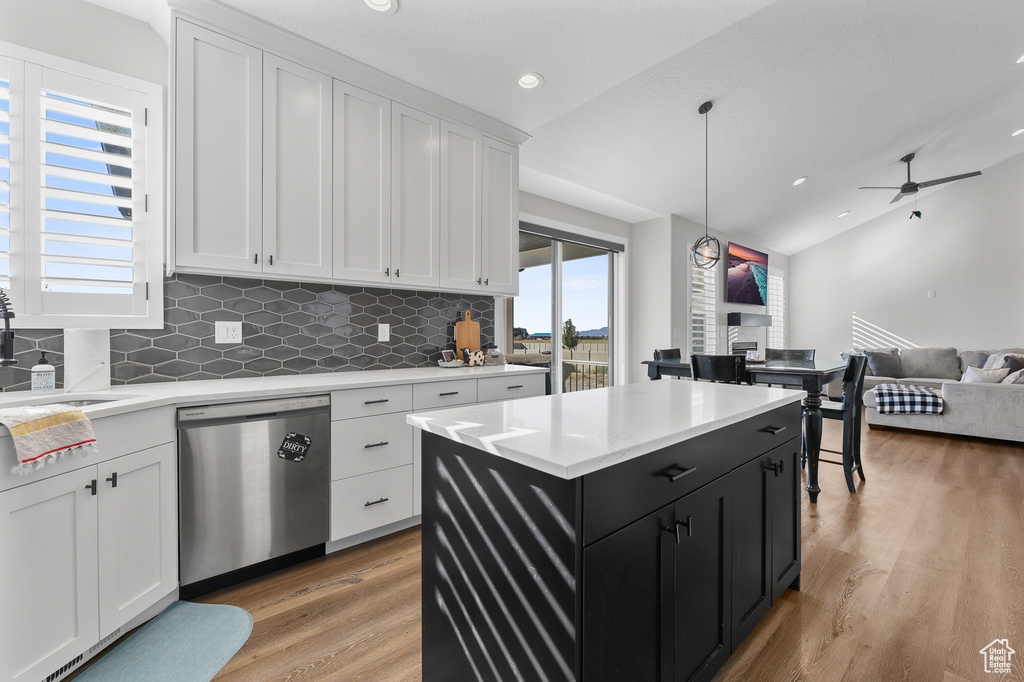 Kitchen with white cabinets, hanging light fixtures, ceiling fan, and stainless steel dishwasher