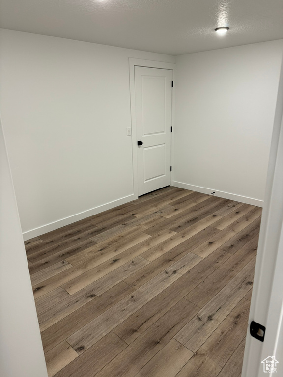 Spare room featuring dark wood-type flooring