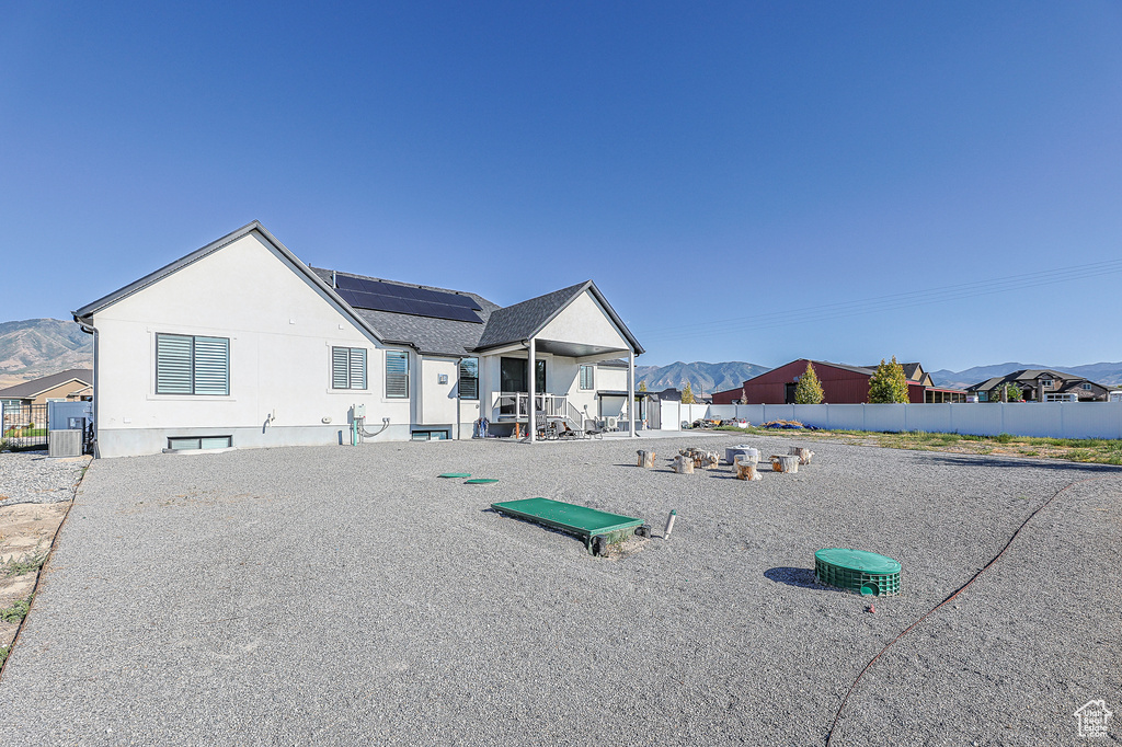 Rear view of property with a patio area and a mountain view