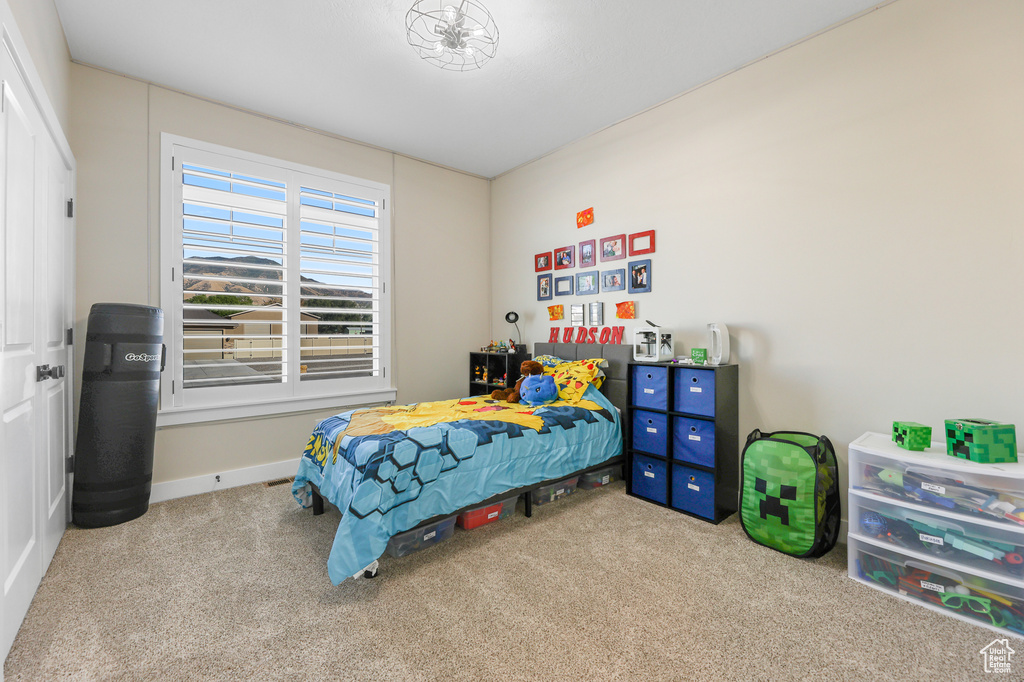 Bedroom featuring light carpet