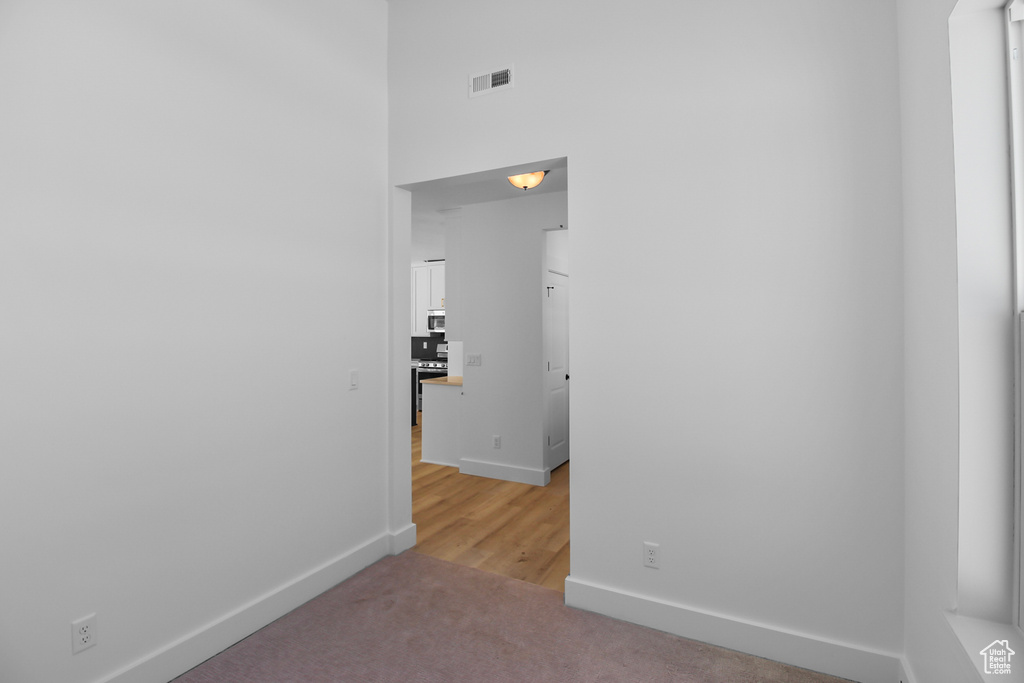 Corridor with light colored carpet