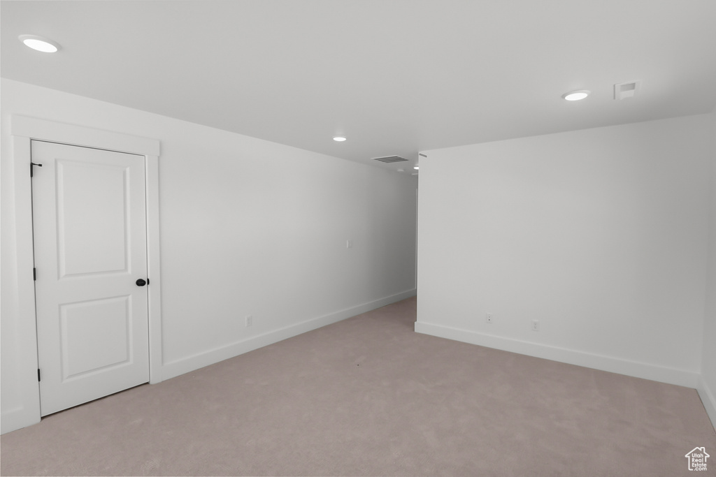 Unfurnished room featuring light colored carpet