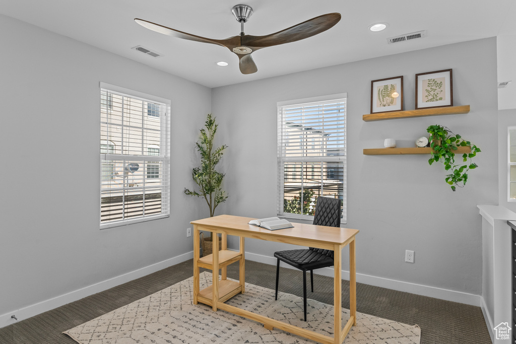 Carpeted home office with ceiling fan