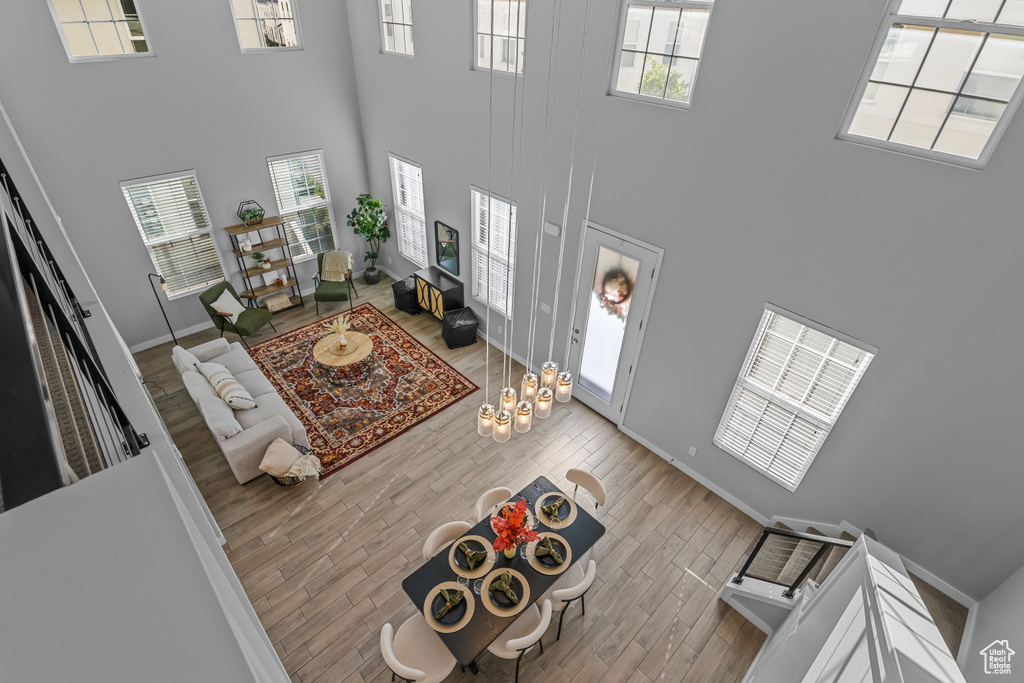 Foyer featuring a towering ceiling and light hardwood / wood-style flooring