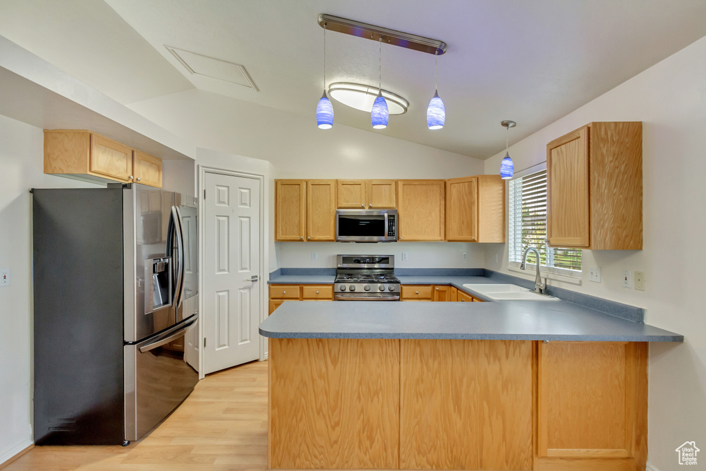 Kitchen with light wood-type flooring, appliances with stainless steel finishes, sink, light brown cabinets, and kitchen peninsula