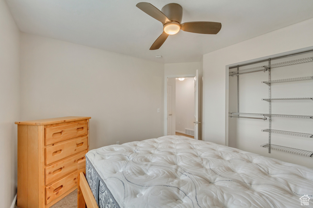 Bedroom featuring carpet flooring, a closet, and ceiling fan