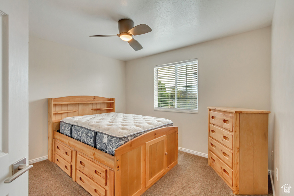 Bedroom featuring ceiling fan and light carpet