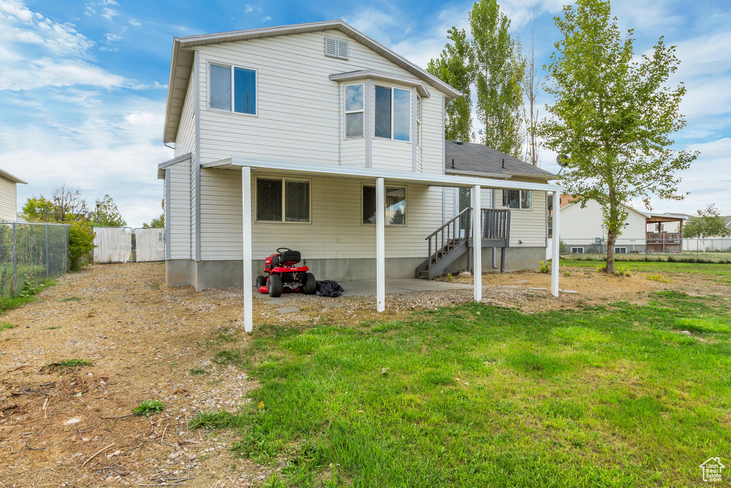 Rear view of house featuring a yard