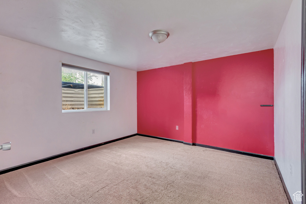 Empty room featuring light carpet