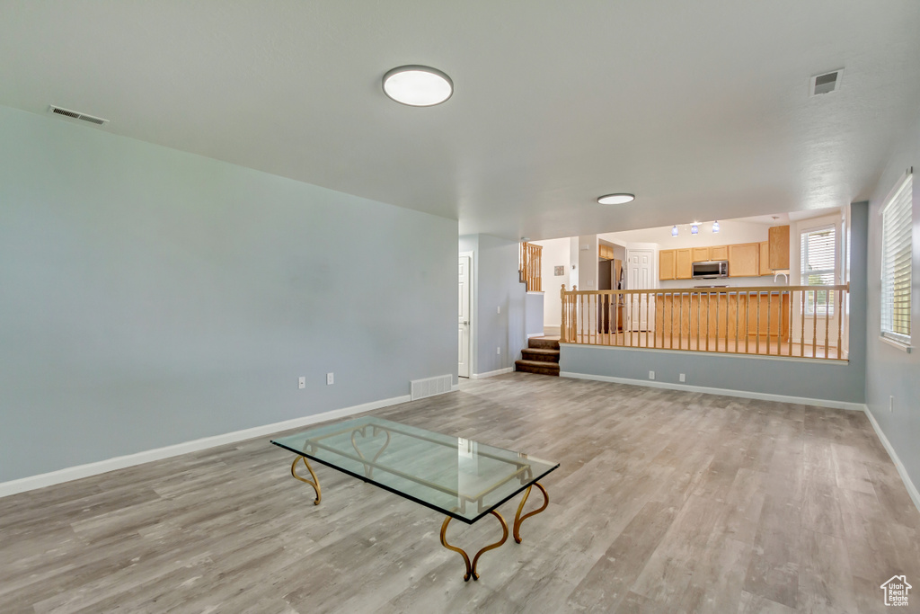 Unfurnished living room with light hardwood / wood-style floors