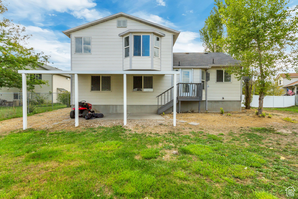 Back of property featuring a yard