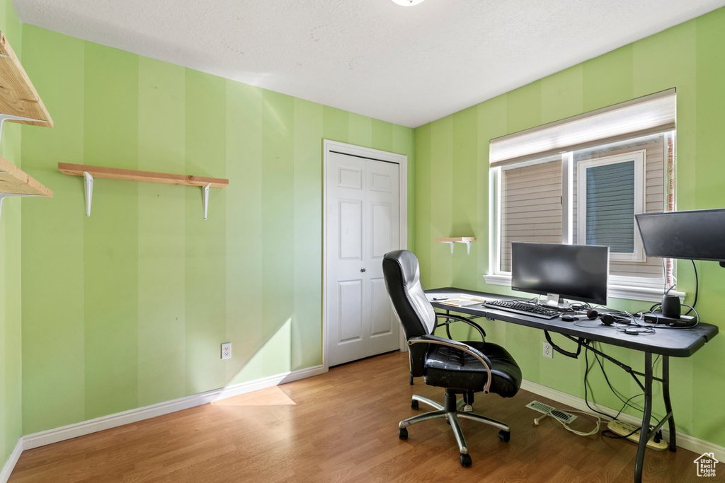 Office area featuring light hardwood / wood-style flooring