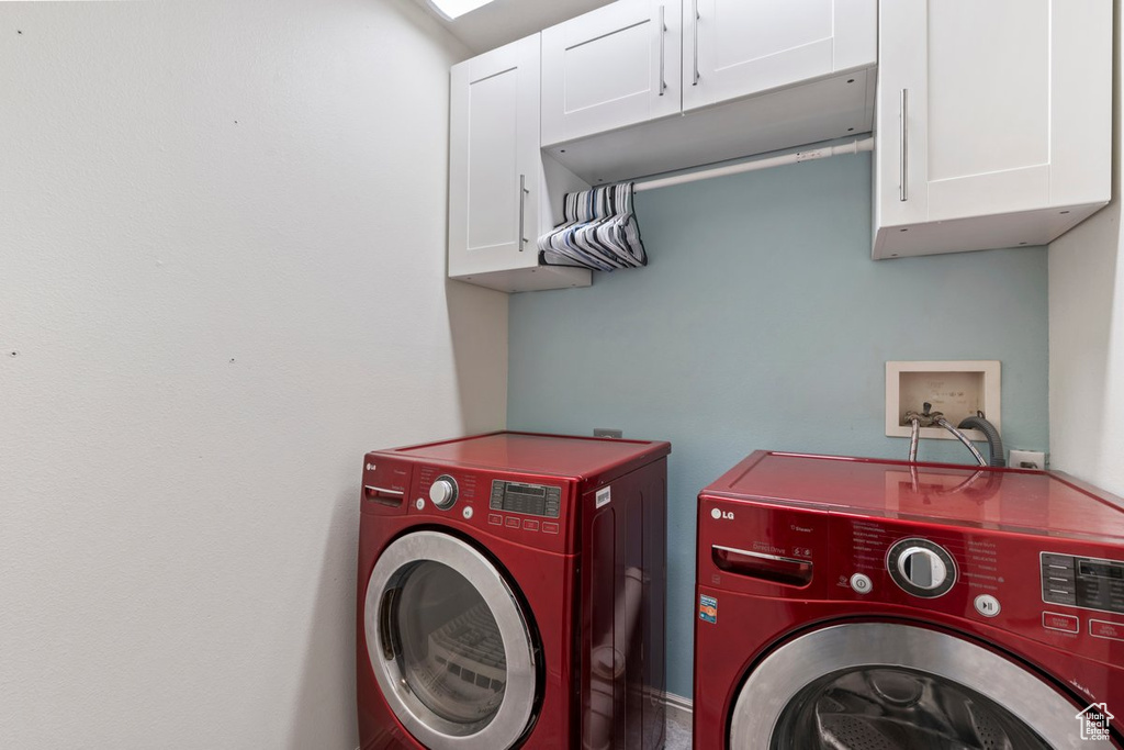 Laundry area with cabinets and separate washer and dryer