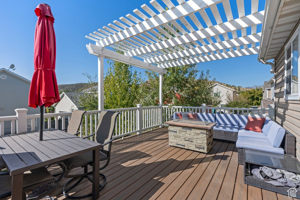 Wooden deck featuring a pergola