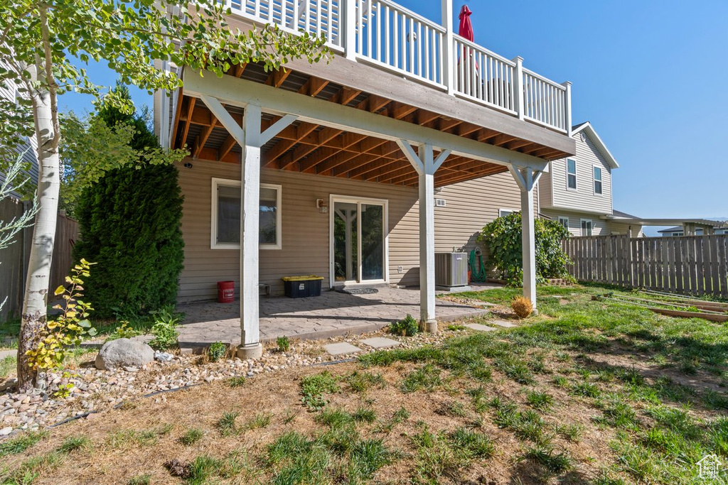 Back of house featuring central air condition unit and a patio area