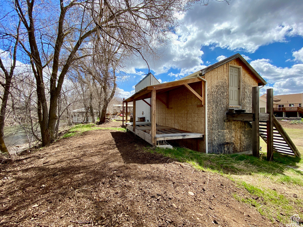 View of property exterior featuring a wooden deck