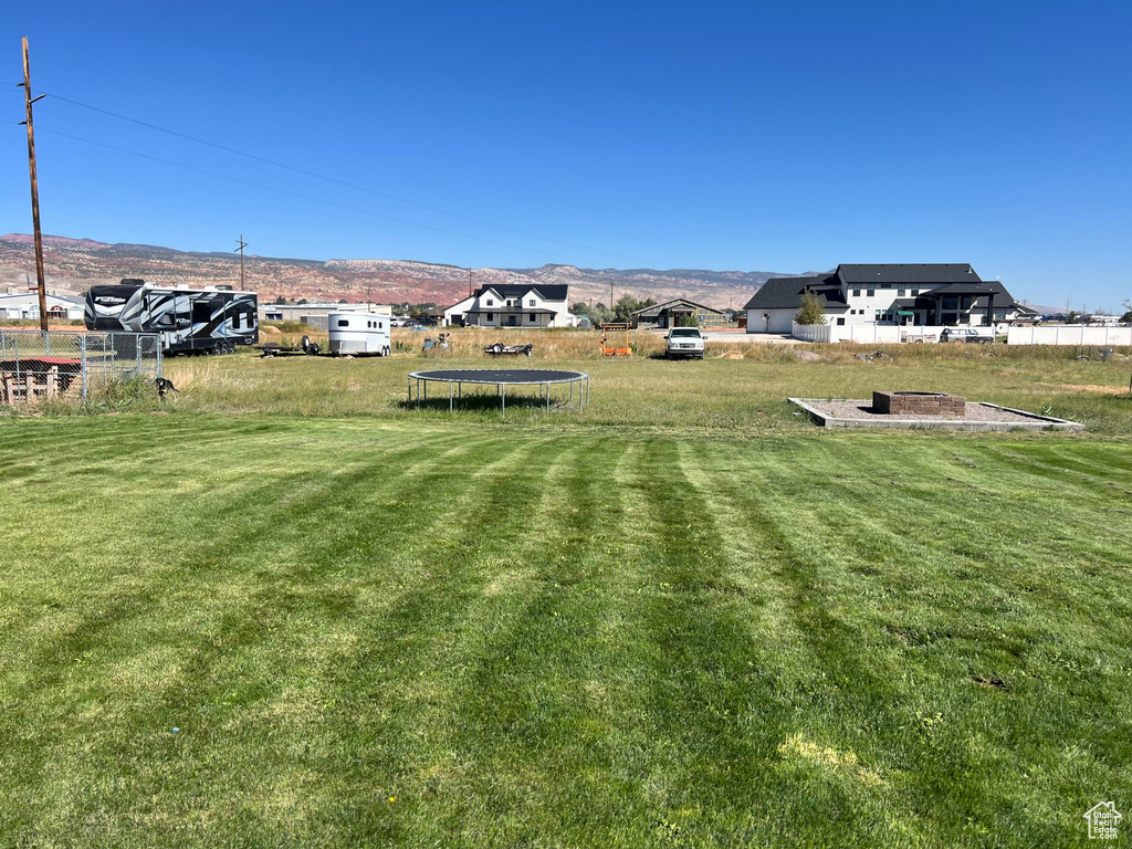 View of yard with a mountain view and a trampoline