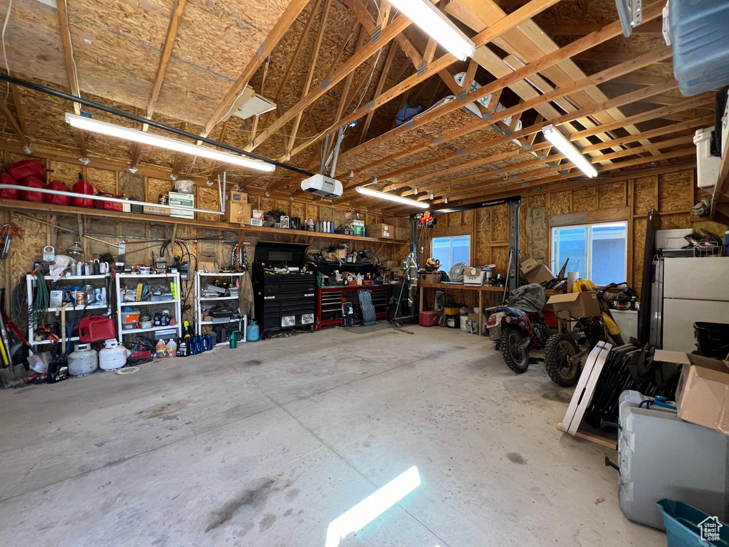 Garage with a workshop area and a garage door opener