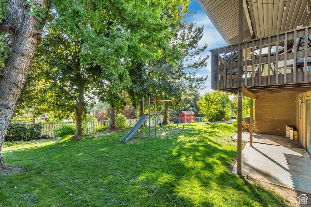 View of yard with a playground and a patio