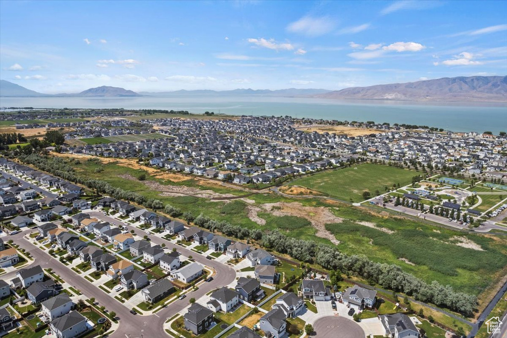 Drone / aerial view featuring a water and mountain view