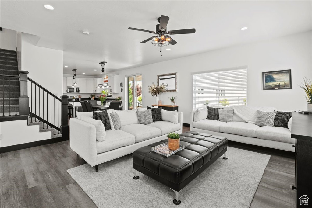 Living room featuring a wealth of natural light, ceiling fan, and dark hardwood / wood-style floors