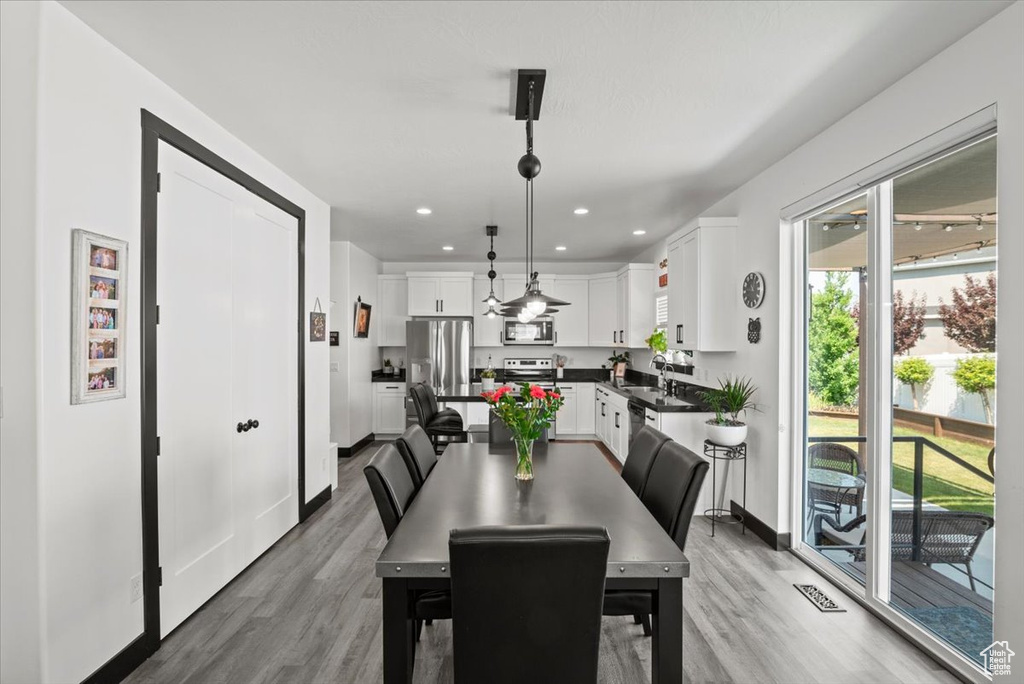 Dining room with a wealth of natural light and wood-type flooring