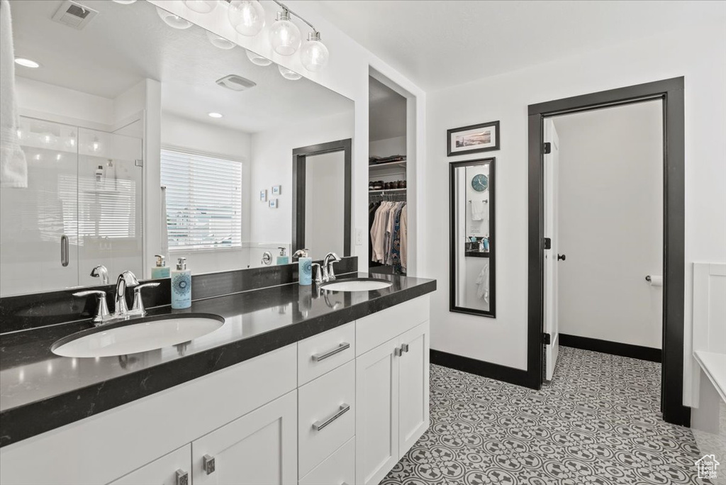 Bathroom with an enclosed shower and vanity