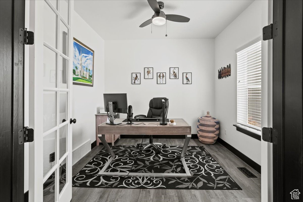 Office with hardwood / wood-style floors, ceiling fan, and a wealth of natural light